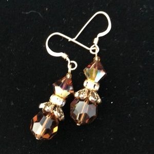 Brown Swarovski crystal earrings with gold trim.